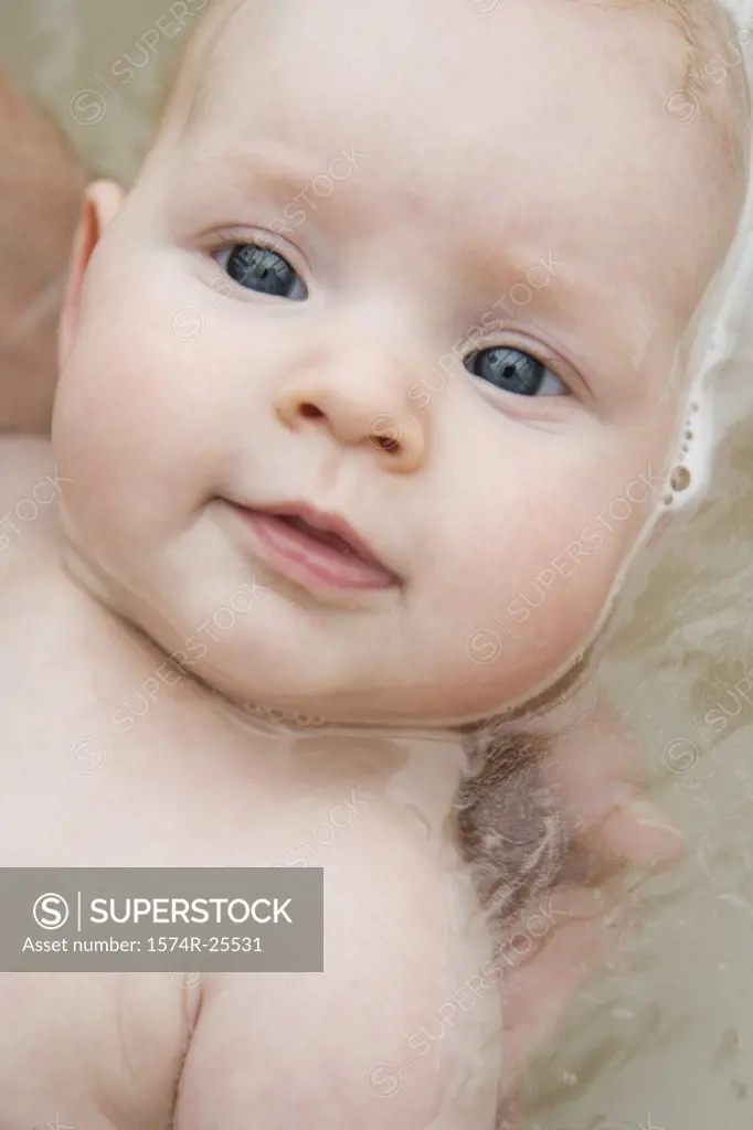 Portrait of a baby taking a bath