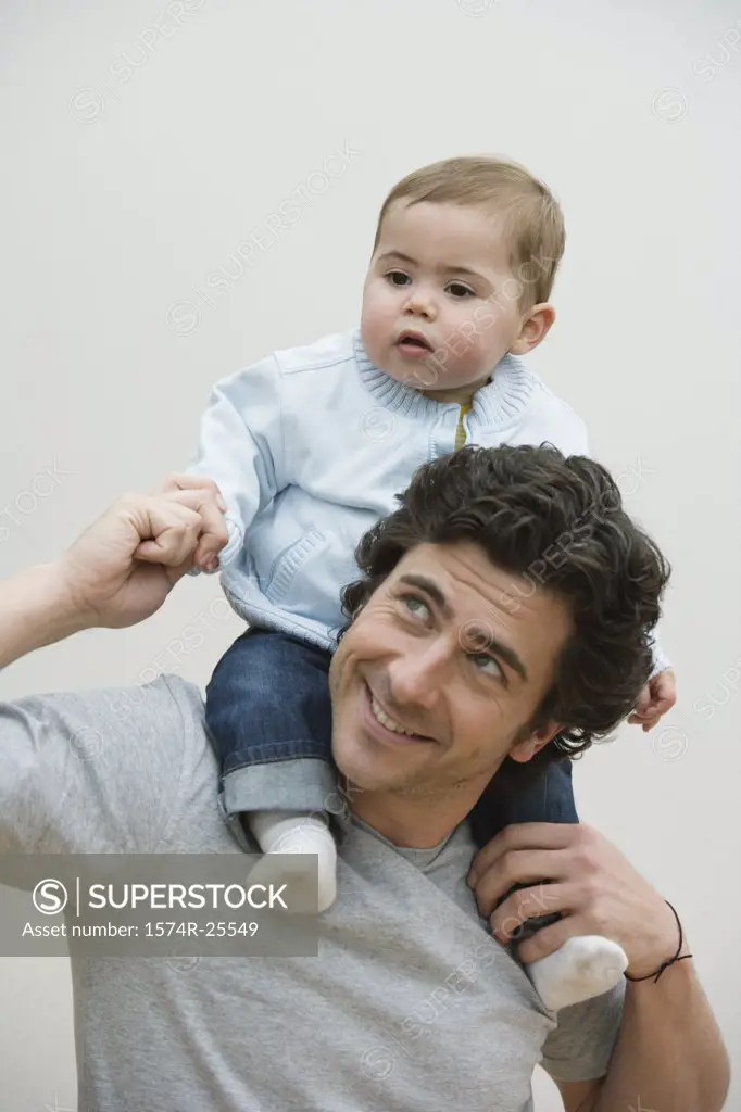 Mid adult man carrying his son on his shoulders