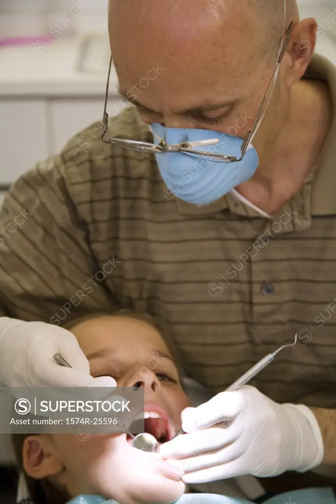 Close-up of a dentist examining a boy