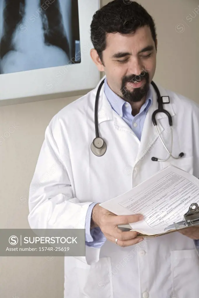 Male doctor holding a clipboard