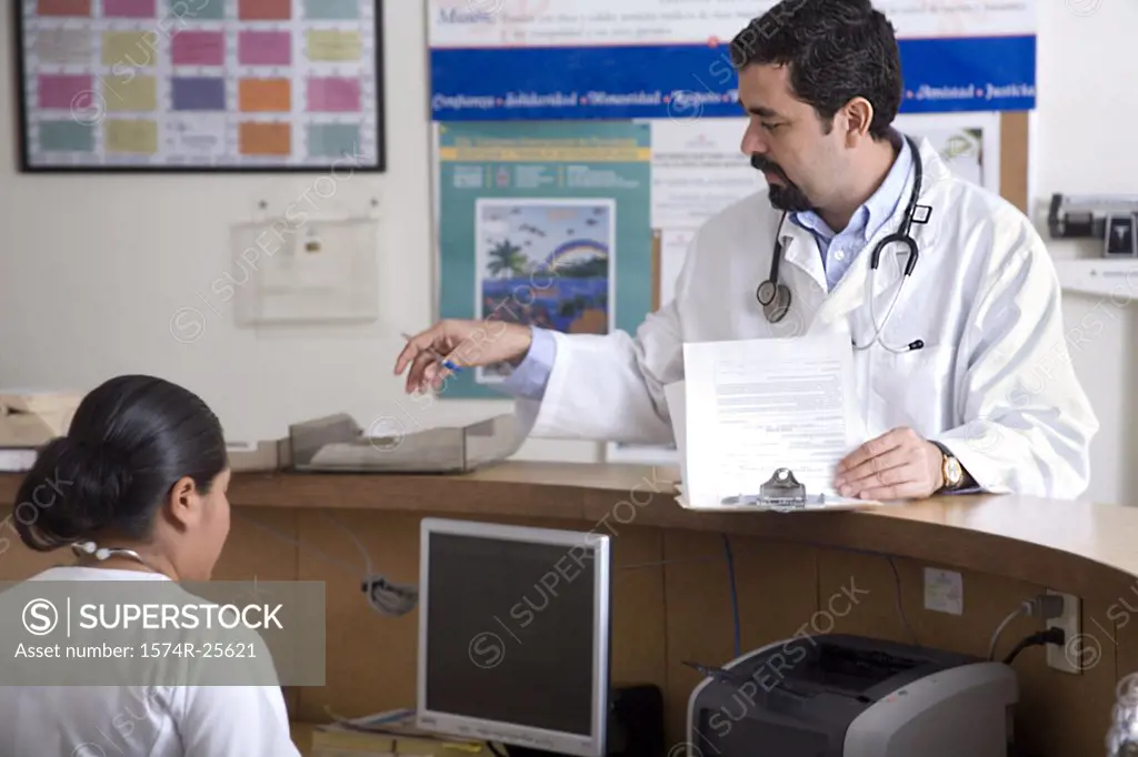 Male doctor standing at a counter