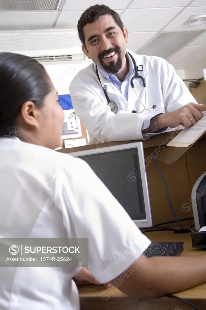 Male doctor showing the report to a female nurse