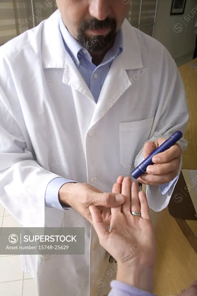 Male doctor taking a blood sample from a patient's finger