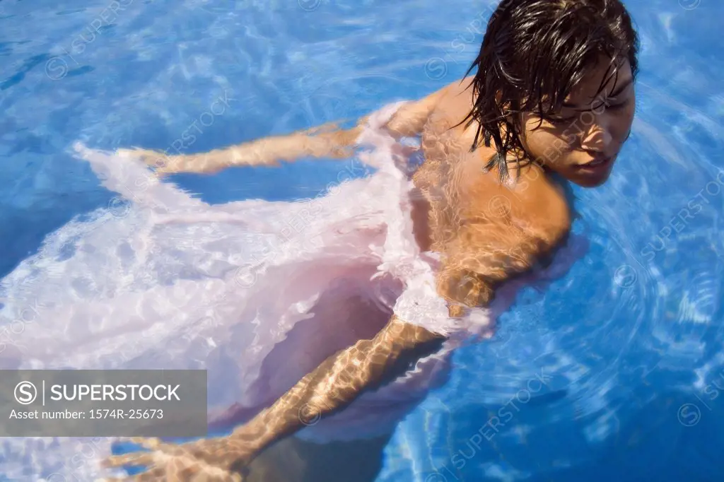 High angle view of a young woman swimming in a swimming pool