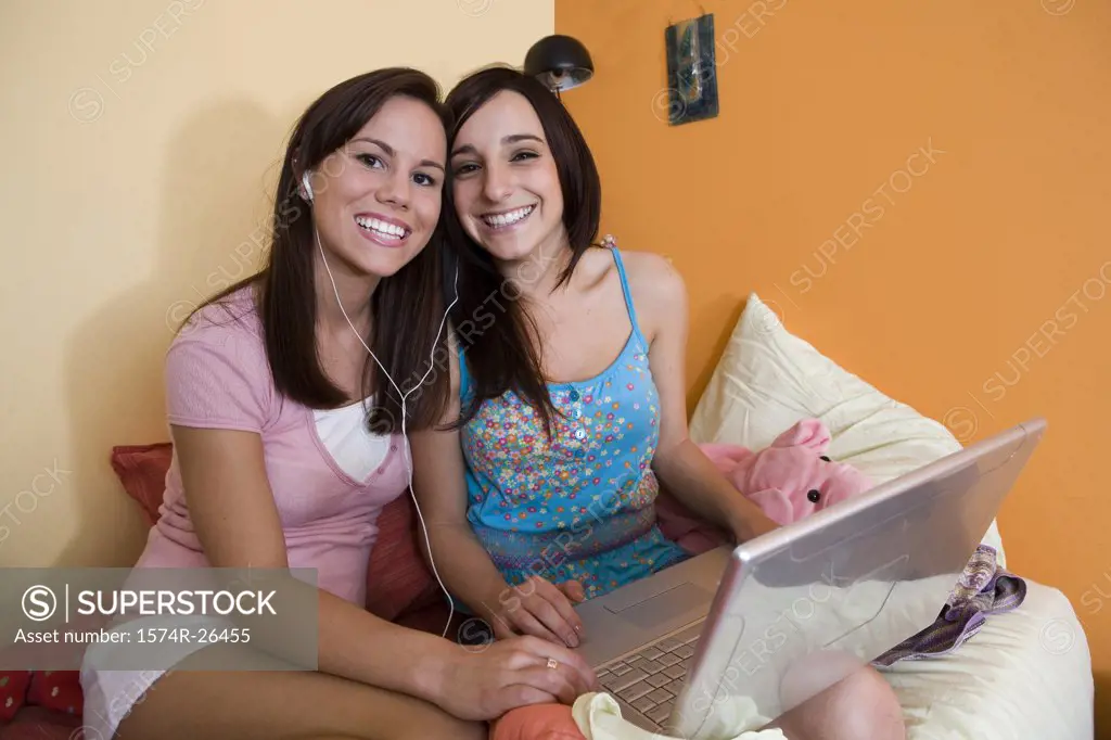 Teenage girl and a young woman using a laptop