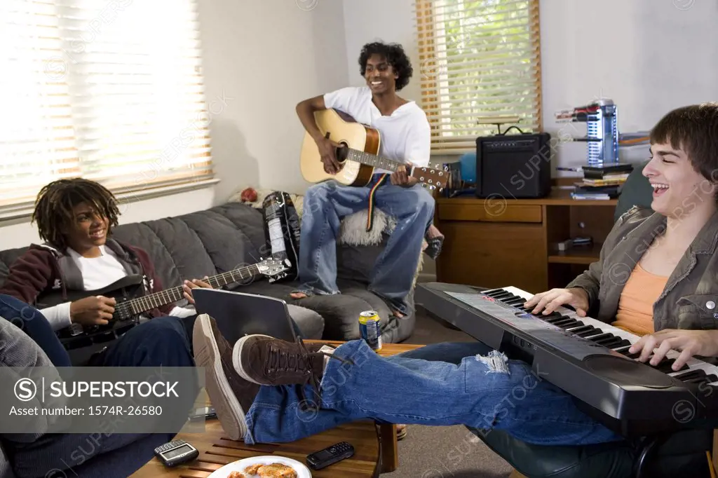 Teenage boy and two young men playing music