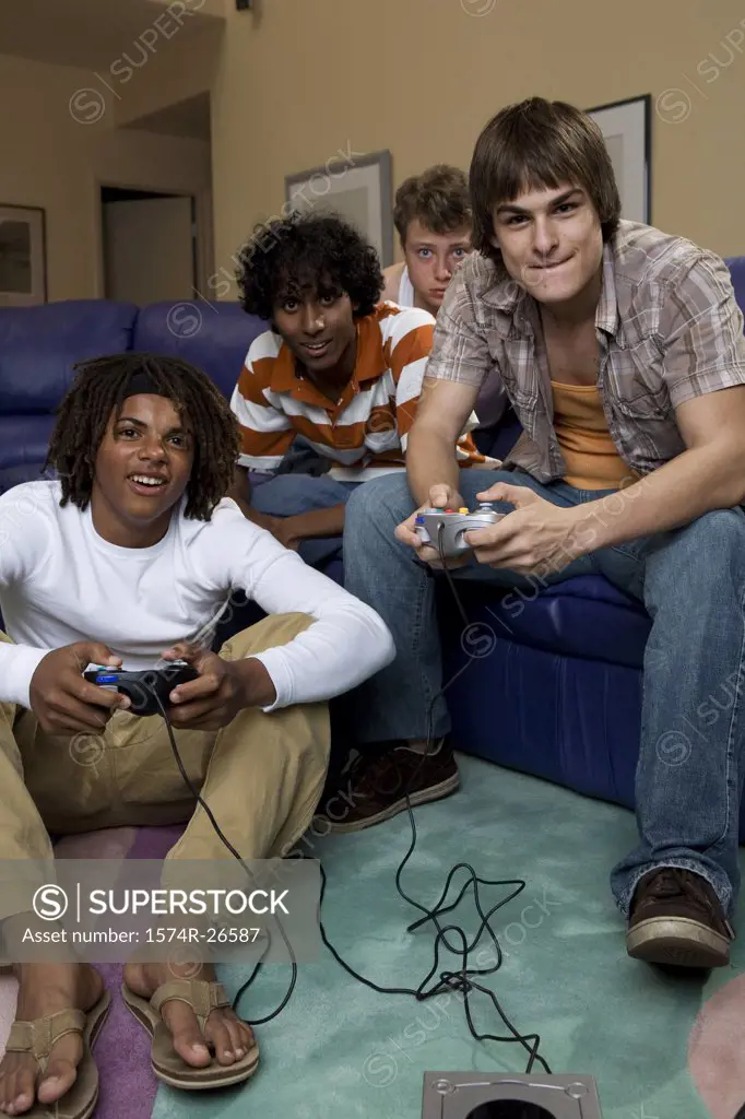 Teenage boy and a young man playing a video game