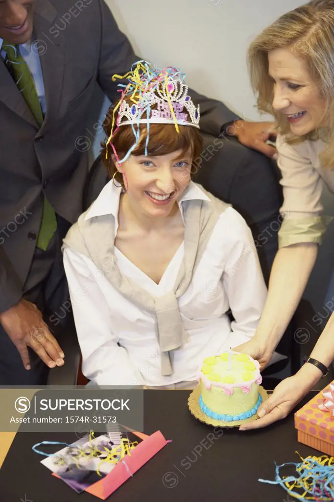 Portrait of a businesswoman celebrating her birthday with her colleagues