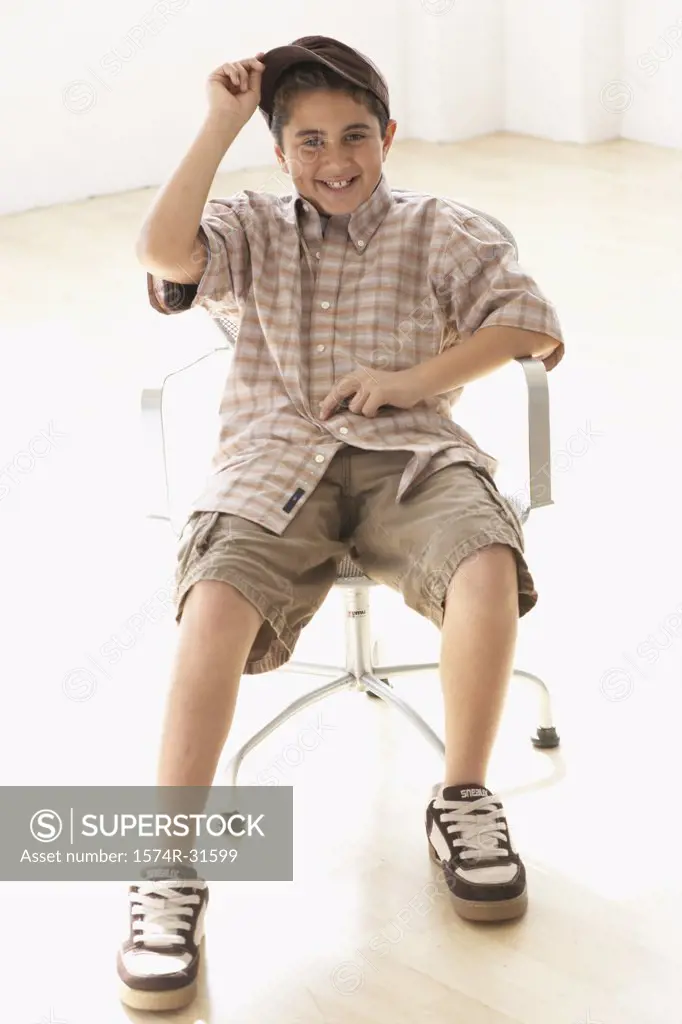 Portrait of a boy sitting in an armchair