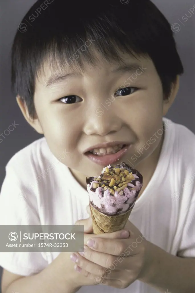 Close-up of a boy eating an ice cream cone