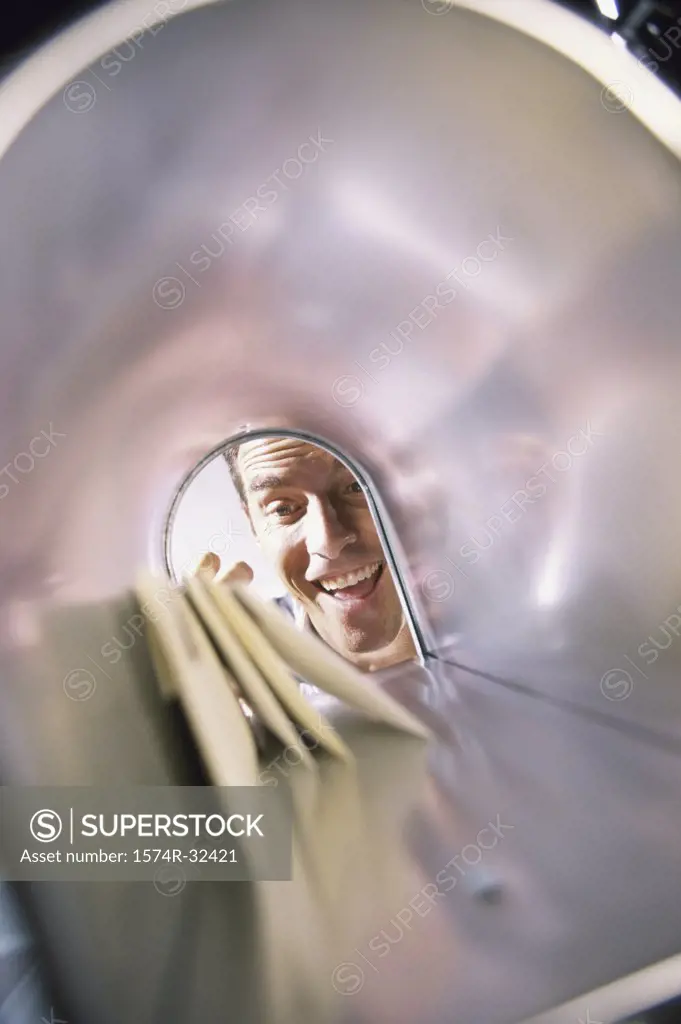 Mid adult man looking into a mailbox
