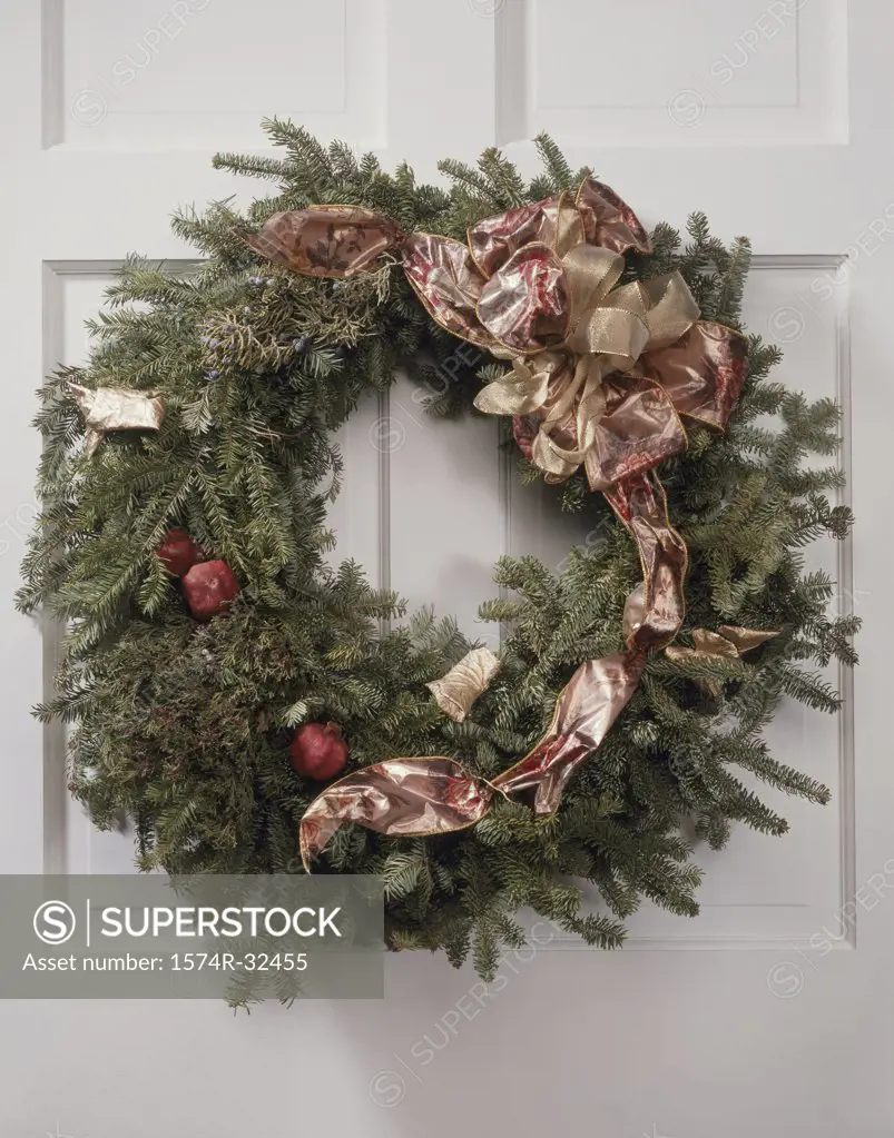 Close-up of a Christmas wreath hanging on a door