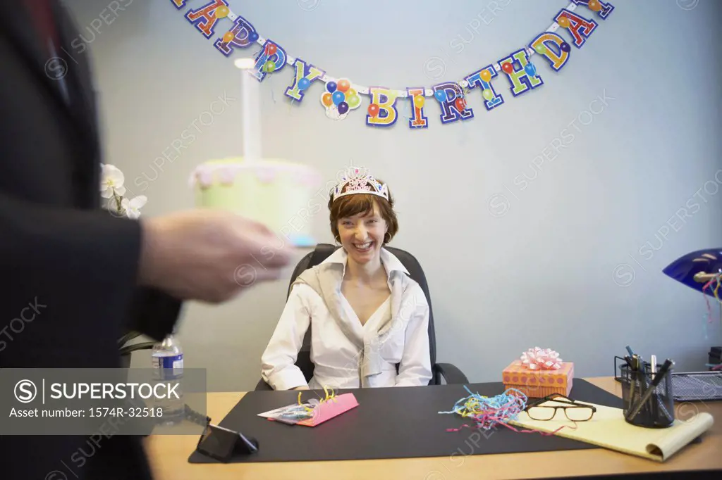 Businesswoman celebrating her birthday in an office