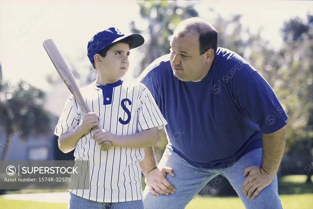 Son playing baseball with his father