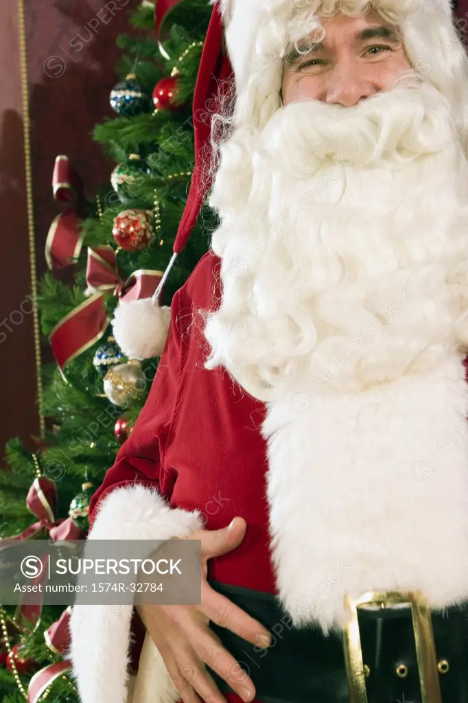 Santa Claus in front of a Christmas tree