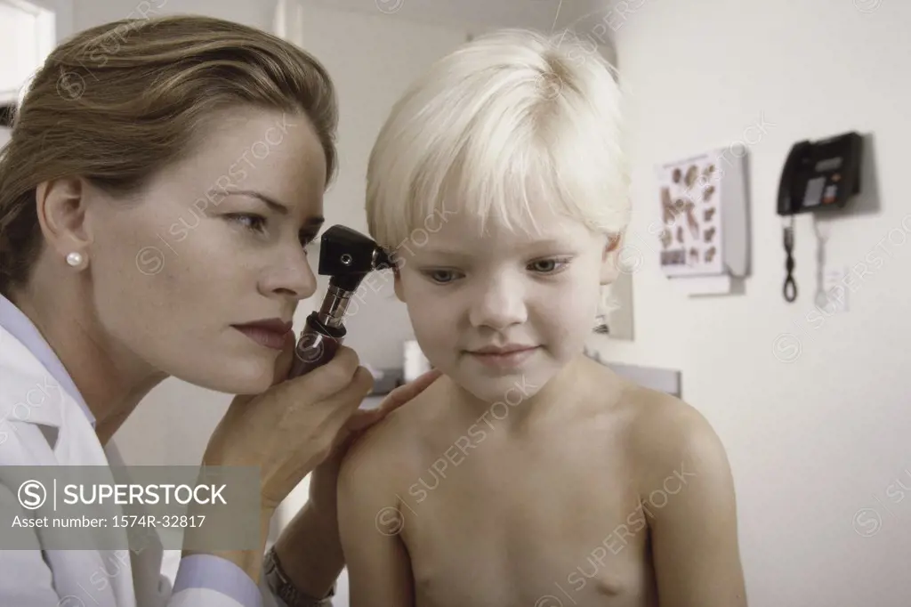 Female doctor examining a girl's ear