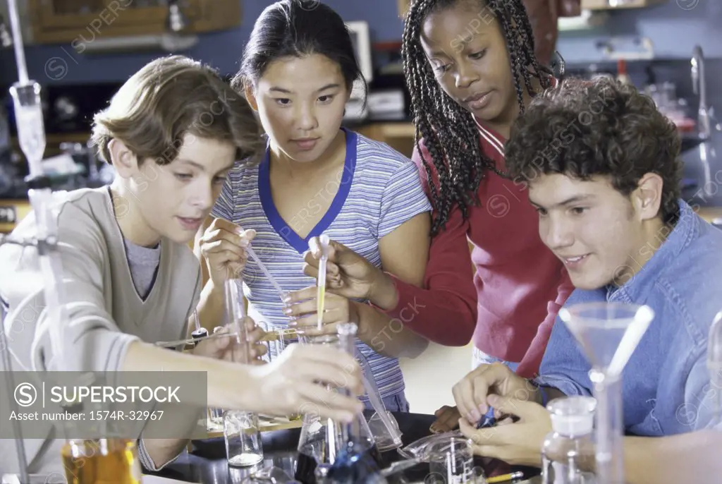 Group of teenagers experimenting in a science lab