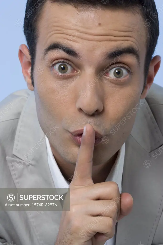 Portrait of a businessman with his finger on his lips