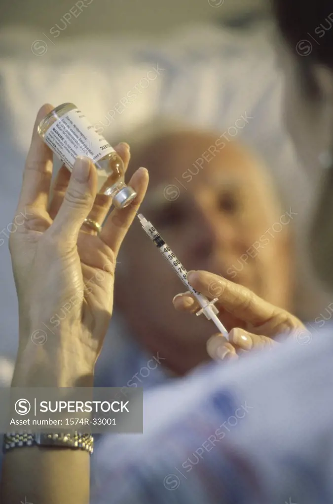 Female nurse preparing an injection