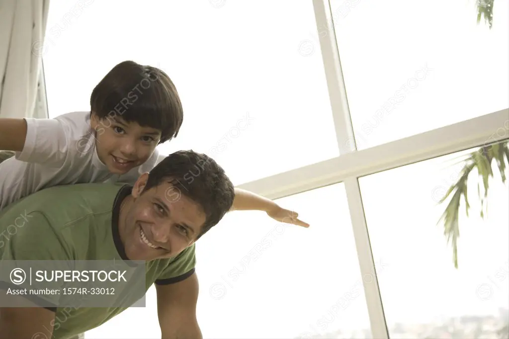 Boy riding piggyback on his father