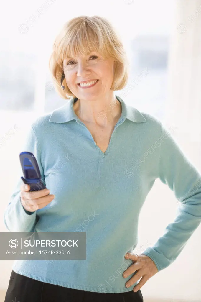 Businesswoman operating a mobile phone and smiling