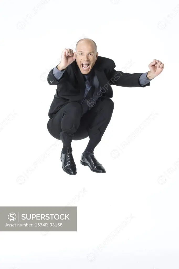 Businessman jumping into the air and looking excited