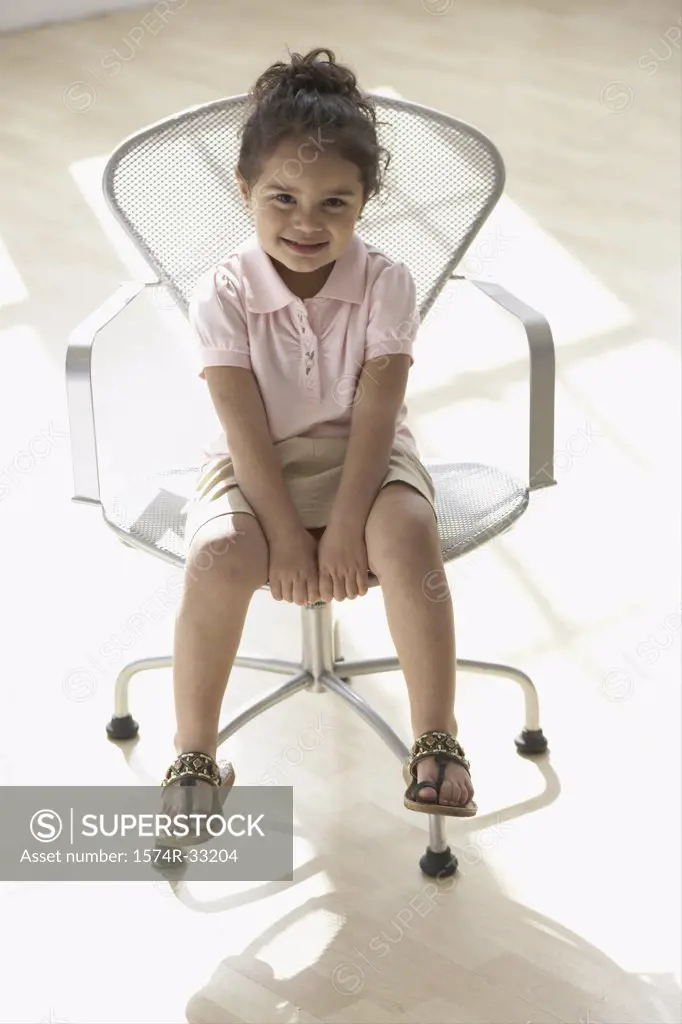 Girl sitting in an armchair