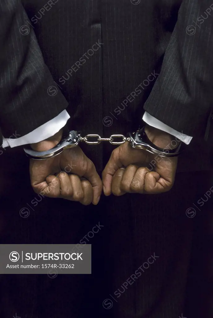 Close-up of a businessman in handcuffs