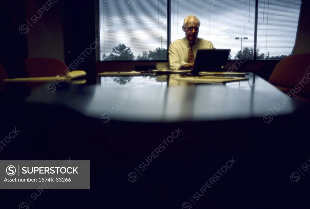 Businessman using a laptop in a conference room