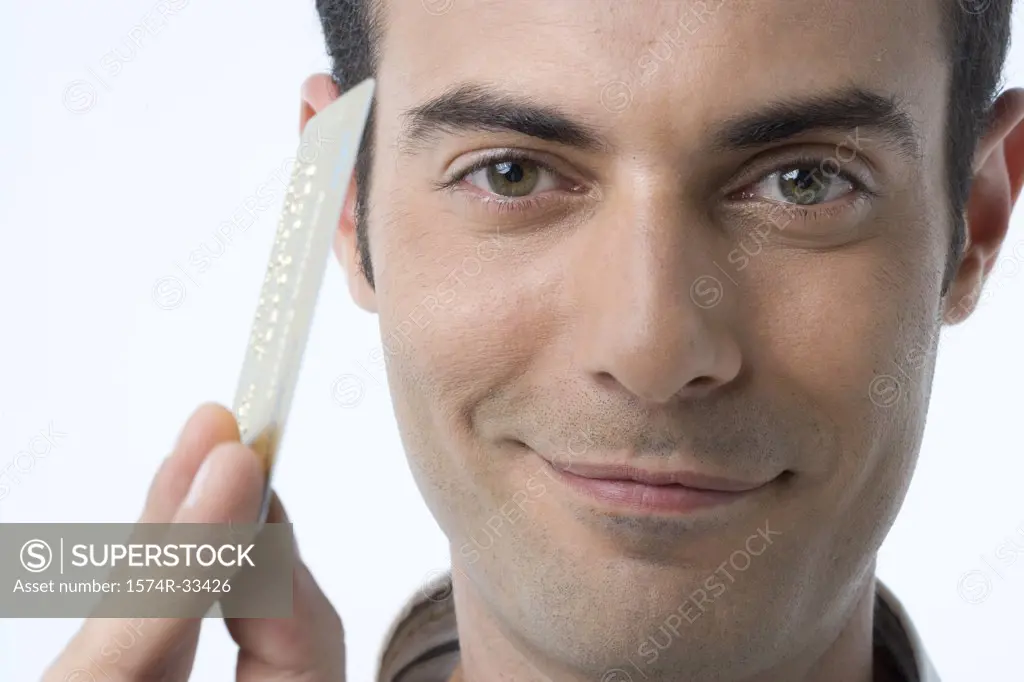Portrait of a young man holding a credit card