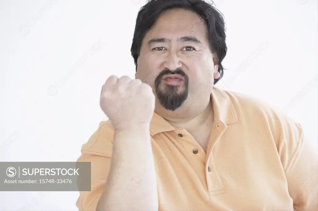 Portrait of a mature man showing his fist