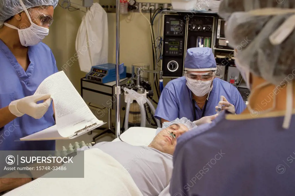 Three surgeons performing a surgery in an operating room