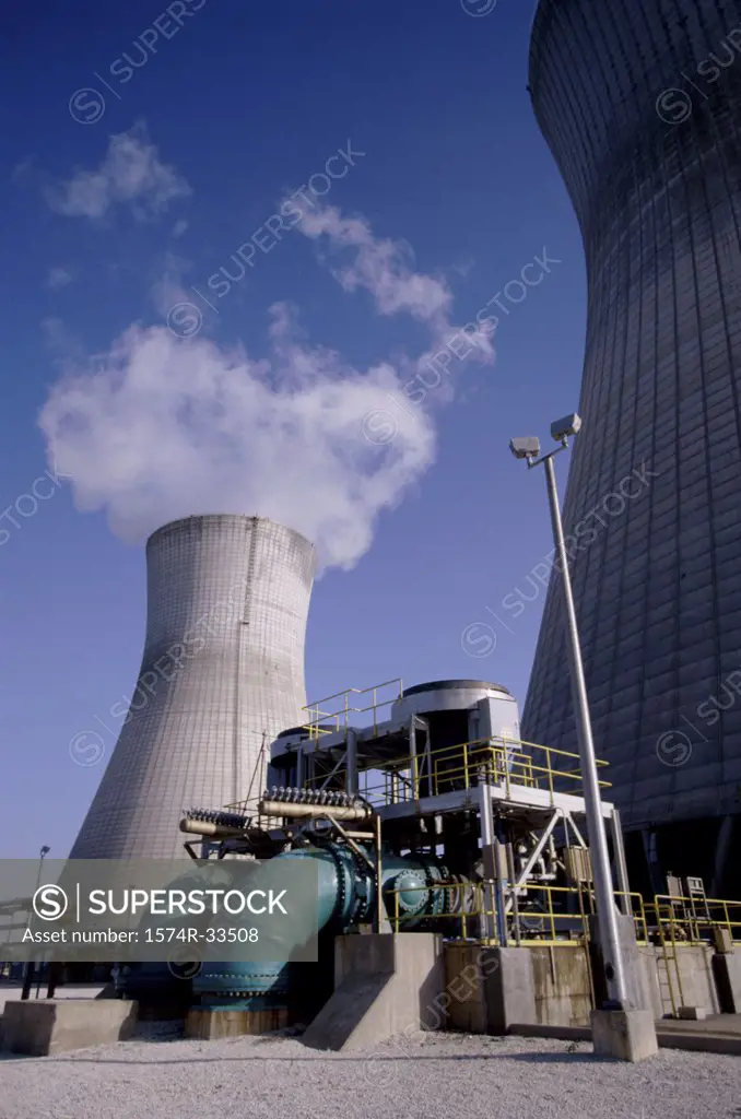 Low angle view of smoke stacks at a power plant