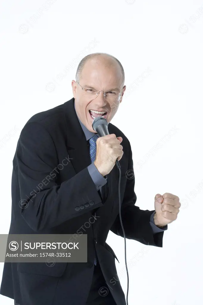 Businessman shouting into a microphone