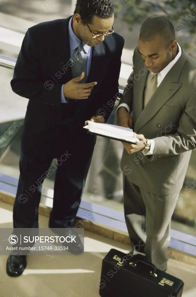 Two businessmen discussing work