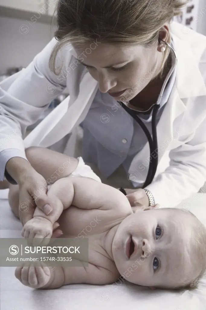 Female doctor examining a baby boy