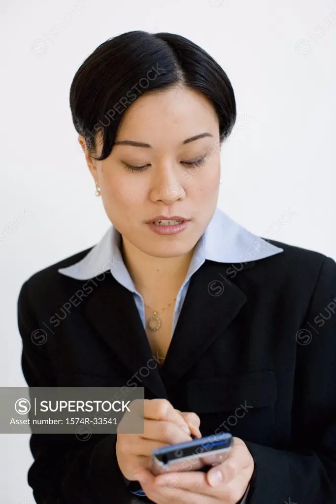 Close-up of a businesswoman operating a personal data assistant with a digitized pen
