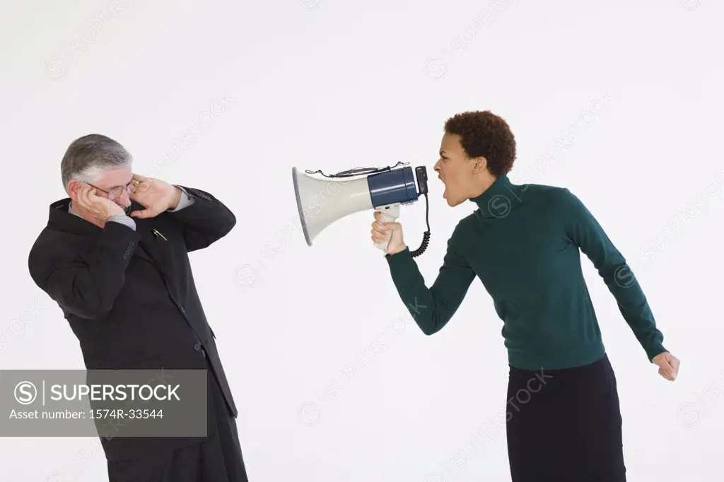 Businesswoman using a megaphone and shouting at a businessman