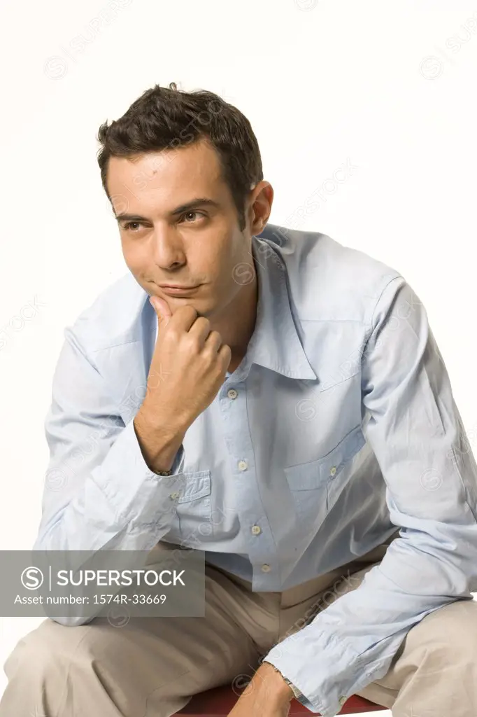 Businessman smirking with his hand on his chin