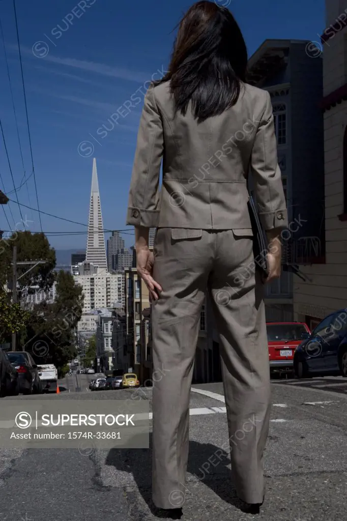 Rear view of a businesswoman standing on the road, San Francisco, California, USA