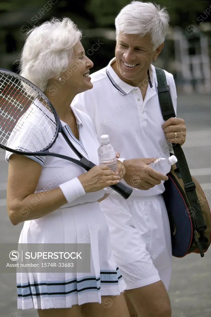 Senior couple together at a tennis court