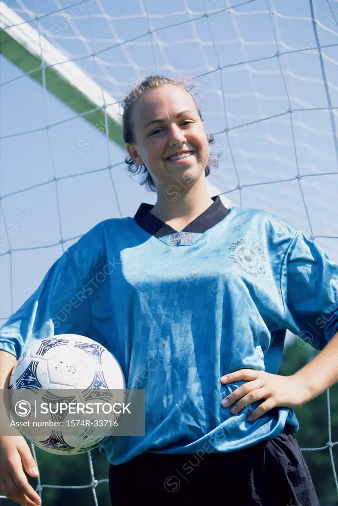 Portrait of a teenage girl holding a soccer ball