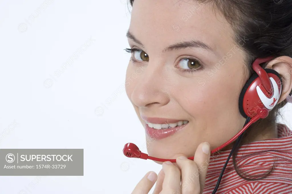 Portrait of a female customer service representative wearing a headset and smiling