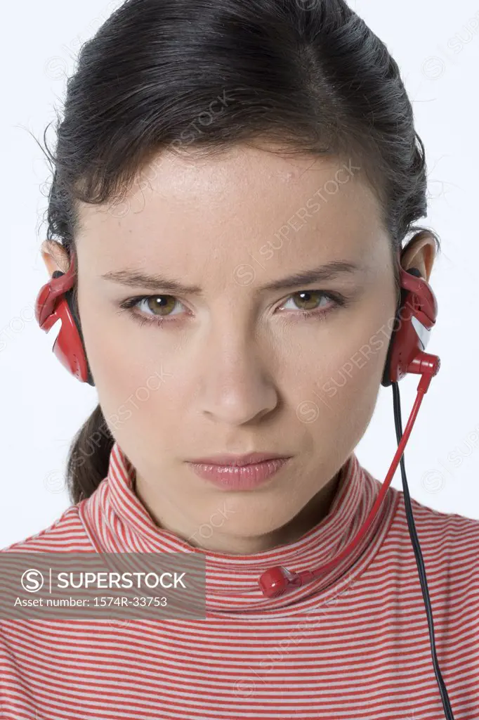 Portrait of a female customer service representative wearing a headset and looking angry