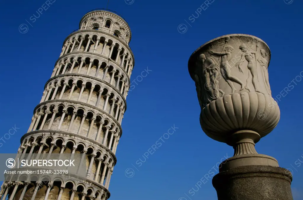 Low angle view of a decorative urn in front of a tower, Leaning Tower, Pisa, Italy
