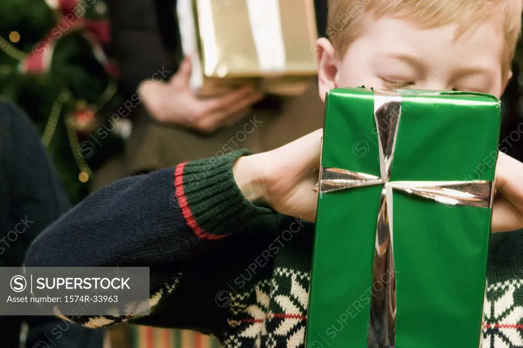 Close-up of a boy opening a Christmas present