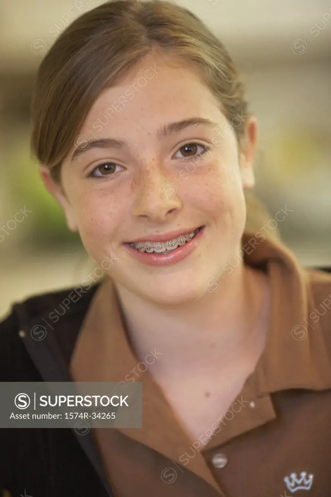 Portrait of a teenage girl smiling with braces on her teeth