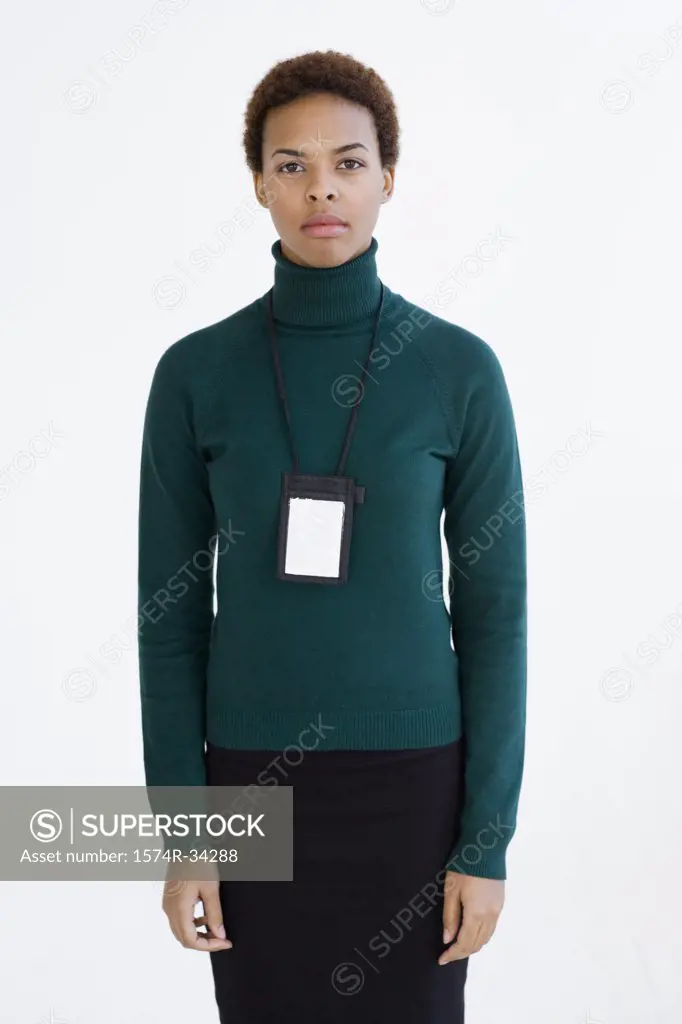 Businesswoman looking serious wearing an id card around her neck