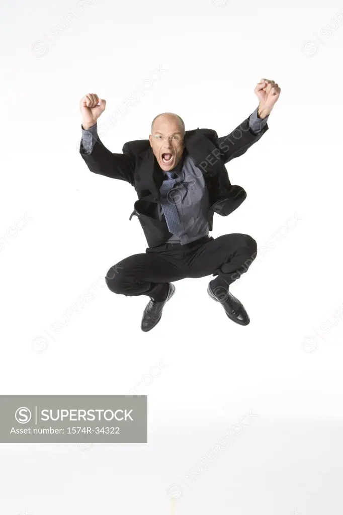 Businessman jumping into the air and looking excited
