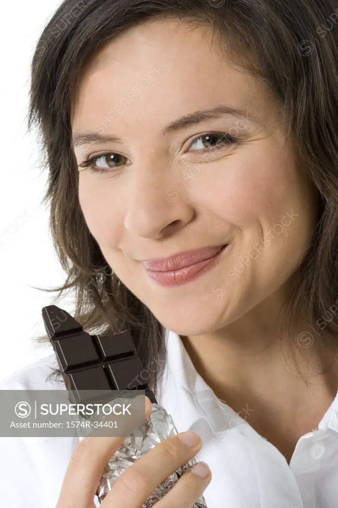 Close-up of a young woman eating chocolate